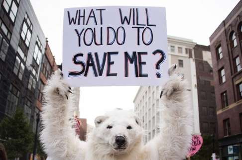 A anti-global warming protester holds up a placard in Cleveland, Ohio, near the US Republican Party’s national convention. Photo: AFP