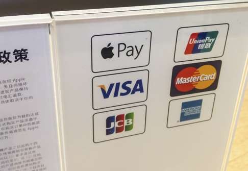 A display explaining that purchases can be made using Apple Pay, as well as other formats, at an Apple store in Shanghai. Photo: AFP