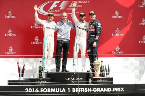Lewis Hamilton celebrates on the podium after winning the British Grand Prix with second placed Nico Rosberg (left), third placed Max Verstappen (right) of Red Bull and Mercedes Executive Director Paddy Lowe. Photo: Reuters