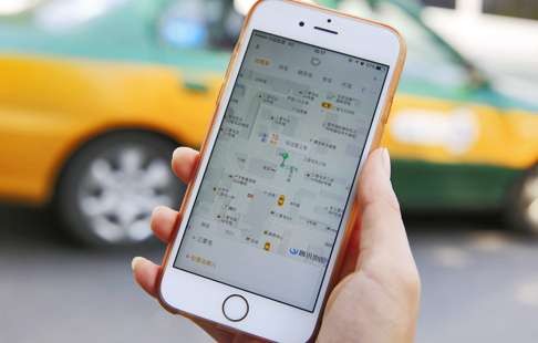 A commuter using the Didi Chuxing app on her iPhone. Photo: PA