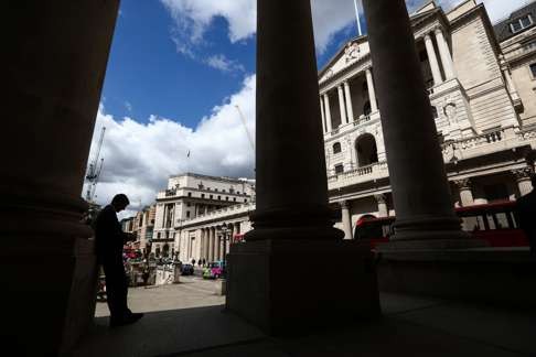 A businessman checks his mobile phone outside the Bank of England (BOE) in London as the economy reels from Britain’s decision to quit the European Union. Photo: Bloomberg
