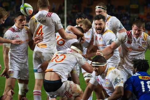 Chiefs players celebrate after scoring a try against the Stormers, during their quarterfinal play-off of the 2016 Super Rugby competition, being played at Newlands stadium, on July 23, 2016, in Cape Town. / AFP PHOTO / RODGER BOSCH