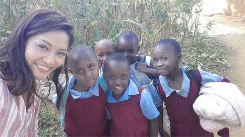 Kannie Chung runs into some students in a Kenyan village.