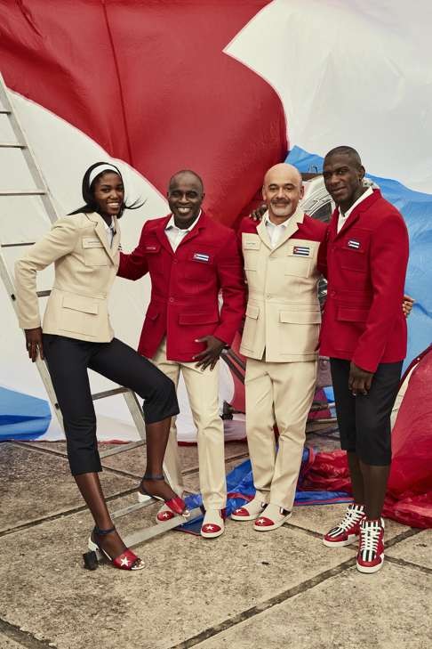 Henri Tai (second from left), Christian Louboutin and athletes show off Cuban Olympic ceremonial outfits.