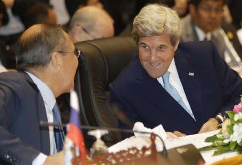 Russia's Foreign Minister Sergey Lavrov, left, talks with US Secretary of State John Kerry during the 6th East Asia Summit Foreign Minister's meeting in Vientiane, Laos, on Tuesday. Photo: AP