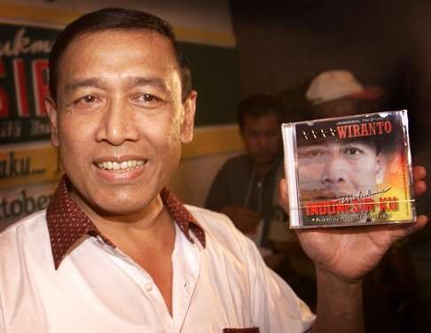 Wiranto shows the compact disc of his 10-song album, called For You My Indonesia in 2000. File photo: AP