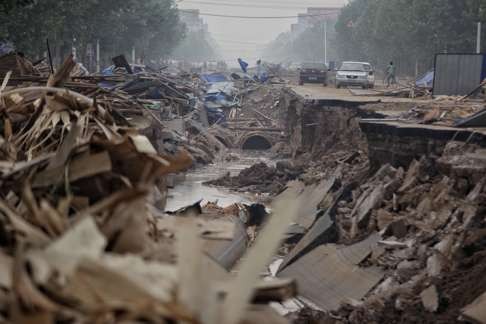 Road damaged the floods in Xingtai, Hebei Province. Photo: Reuters