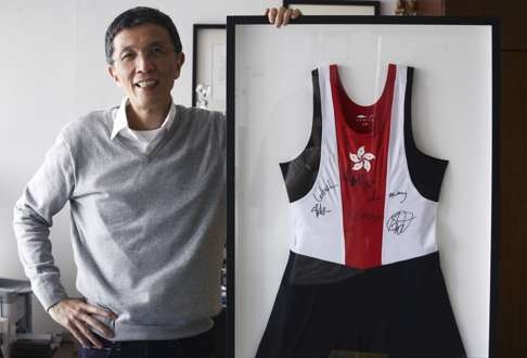 Edwin Keh Yee-man, CEO of the Hong Kong Research Institute of Textiles and Apparel, with a signed outfit worn by a member of the Hong Kong rowing team in the 2014 Asian Games.
