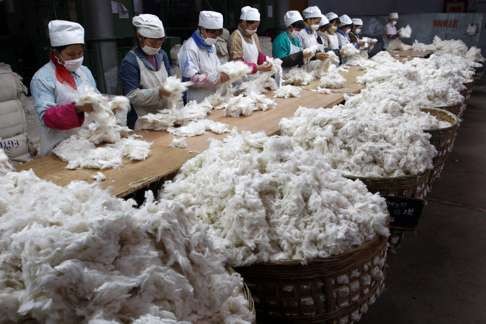 Workers sort cotton at a textile factory in Suining, Sichuan province. Photo: Reuters