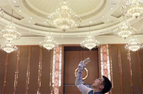 In this July 22 file photo, a waiter readies a conference room ahead of the G20 finance ministers and central bank governors meeting in Chengdu, Sichuan province. Photo: AP