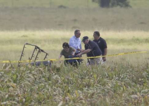 The partial frame of the hot air balloon is visible above a crop field. Photo: TNS