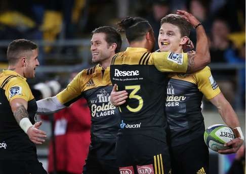 Beauden Barrett (right) of the Hurricanes celebrates with teammates. Photo: AFP