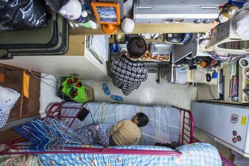 A woman and her son in their 60 square foot subdivided flat in Hong Kong. Photo: Reuters