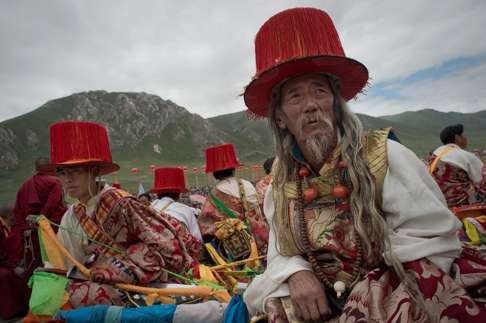 Locals in traditional dress wait to perform at the festival. Photo: AFP