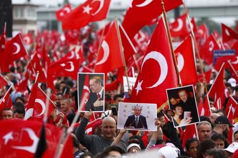 Supporters of Turkish President Tayyip Erdogan wave Turkish flags in Cologne. Photo: Reuters