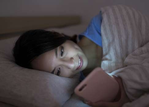 Using your smartphone in bed might disturb your sleep and strain your eyes.