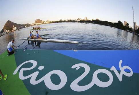Rowers train on the lagoon. REUTERS.