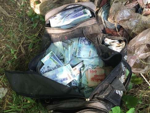 Taiwanese police found some of the cash in a hillside park in Taipei on July 20. Photo: SCMP Pictures