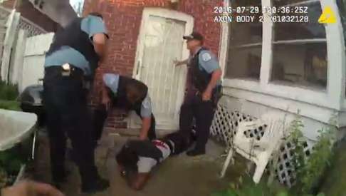 A frame grab taken from a body cam video shows police officers detaining O'Neal. Photo: EPA
