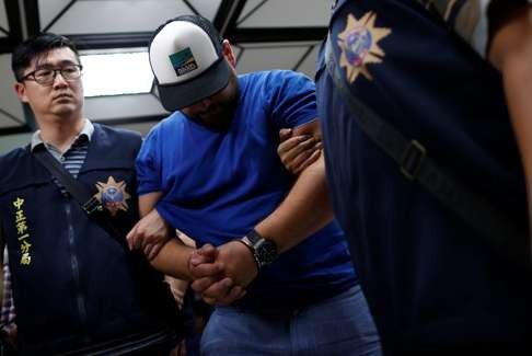 A Romanian suspect at Taipei police station on July 17. Photo: Reuters