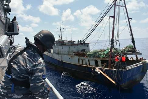 An Indonesian ship arrests a Chinese fishing boat off the Nanuta Islands. Photo: AFP