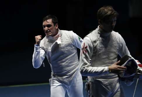 Guilherme Toldo of Brazil, left, celebrates after defeating Cheung Ka Long (AP Photo/Andrew Medichini)