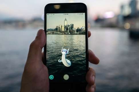 The Dratini character of Pokémon Go, seen in front of the Victoria Harbour. Photo: Bloomberg