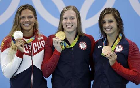 Gold medal winner Lilly King (centre) is flanked by Yulia Efimova (left) and bronze medal winner Katie Meili. Photo: AP