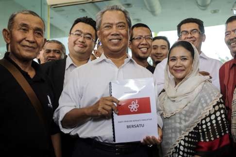 Yassin shows a document of a new party, United Malaysian People’s Party, at the Registrar of Societies office in Putrajaya. Photo: EPA
