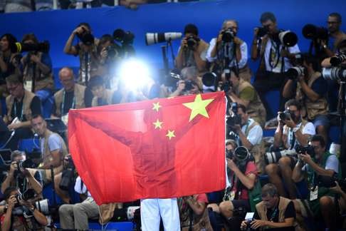 Sun Yang was able to borrow a proper Chinese flag to celebrate with after claiming the gold medal in the men’s 200m freestyle. Photo: EPA