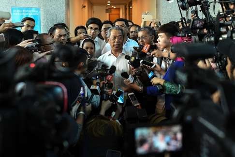 Muhyiddin speaks to the press after submitting his application. Photo: AFP