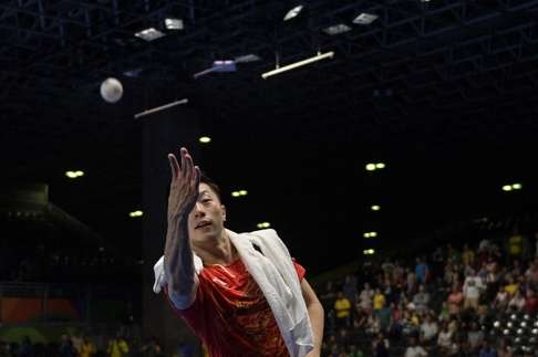 Ma Long throws a ball into the crowd after beating Nigeria’s Quadri Aruna in their men’s singles quarter-final match. Photo: AFP