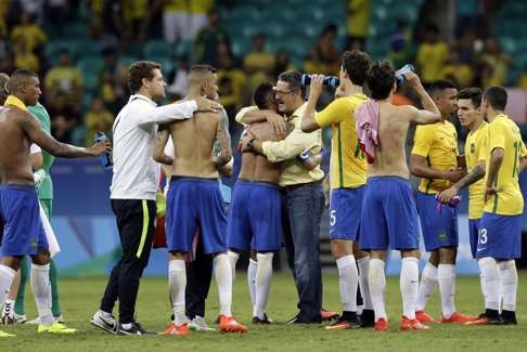 Relieved Brazil players and staff celebrate after a win that put the favourites into the last eight. Photo: AP