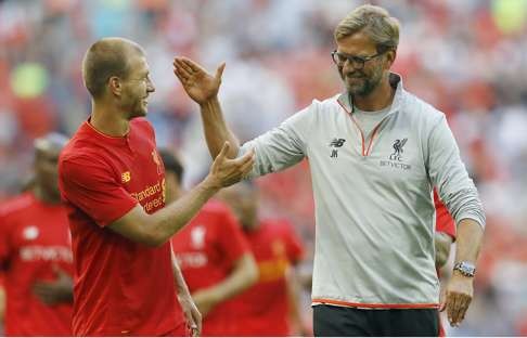 Liverpool's head coach Juergen Klopp, right and Liverpool's Ragnar Klavan gesture, after the team won the International Champions Cup soccer match between Liverpool and Barcelona at Wembley stadium in London, Saturday, Aug. 6, 2016 . (AP Photo/Frank Augstein)