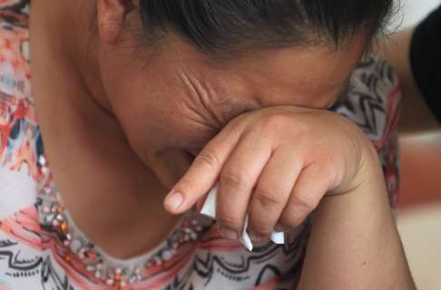 Zhang Zhao weeps upon mention of her son, Zheng Guangliang. Photo: Simon Song