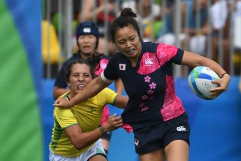 Japan’s Chisato Yokoo fends off a tackle from a Brazilian player. Photo: AFP