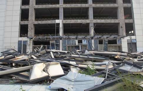 Debris in front of an abandoned building seriously damaged in the blasts. Photo: SCMP Pictures