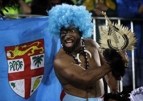A Fiji fan celebrates his country’s gold medal victory over Britain in the men’s rugby sevens. Photo: AP