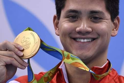 Singapore's Joseph Schooling with his gold medal. Photo: AFP