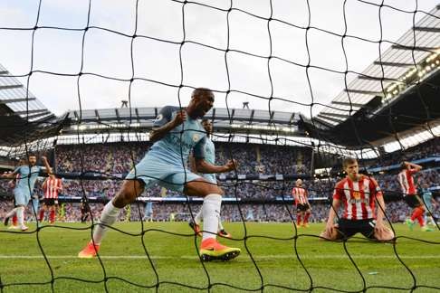 Manchester City's Fabian Delph celebrates after Sunderland's Paddy McNair (second right) scored an own goal. Photo: AFP