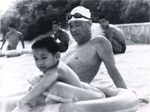 The former Chinese Communist Party leader Zhao Ziyang sunbathes with his grandson at Beidaihe in August 1986. File Photo