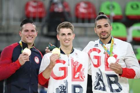 Bronze medallists Alexander Naddour of USA (left), Max Whitlock and Louis Smith. Photo: EPA