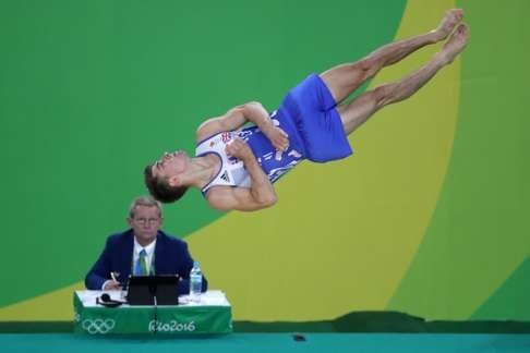 Max Whitlock performs during the men's floor exercise final. Photo: EPA