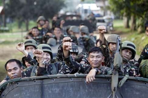 Filipino soldiers on a military truck gesture during Philippine President Rodrigo Duterte's visit to the volatile island of Sulu, southern Philippines. Photo: EPA