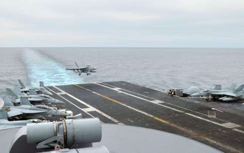 A US fighter jet lands on the USS George Washington aircraft carrier in the South China Sea, amid a significant increase in US warships and aircraft deployed in Asia, sparking a tougher stance from China. Photo: AFP