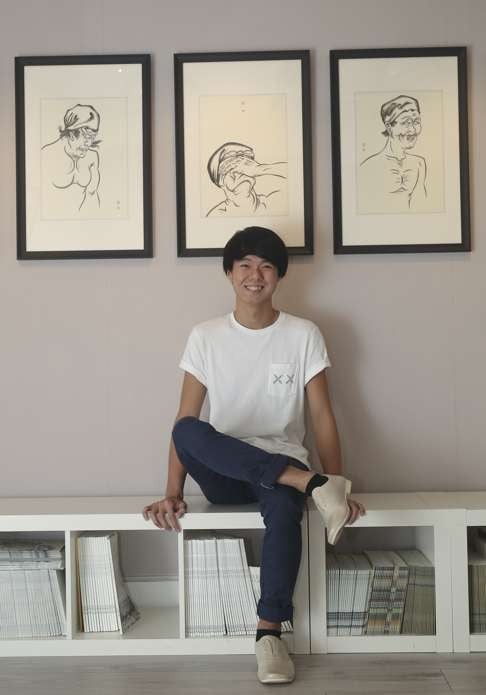 Chan Kwan-lok poses in front of his drawings of kabuki actors at Grotto Fine Art in Central. Photo: Paul Yeung