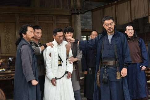 Lau Ching-wan (pointing) and Louis Koo (in white) in Call of Heroes.