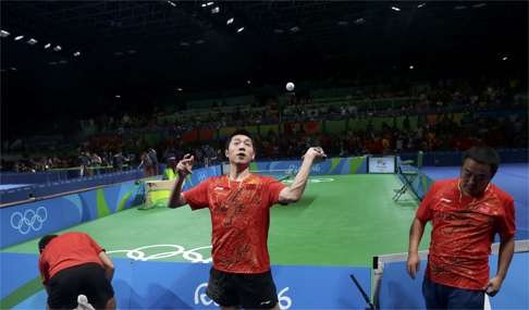 Xu fires balls into the crowd after winning Olympic gold against Japan. Photo: Reuters