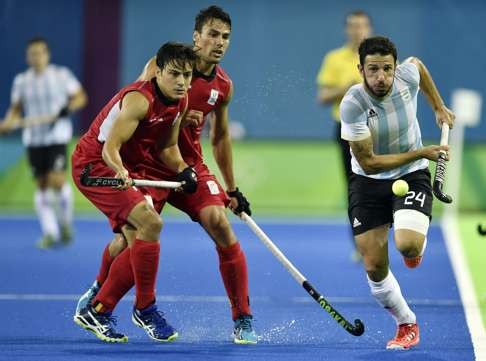 Argentina's Manuel Brunet vies with Belgium's Thomas Briels (left) and Simon Gougnard. Photo: AFP