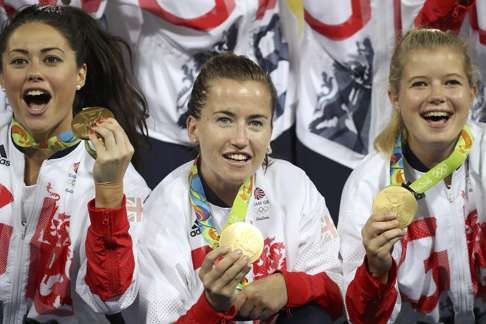 Sam Quek, Shona McCallin and Sophie Bray of Great Britain celebrate winning the gold medal. Photo: Reuters